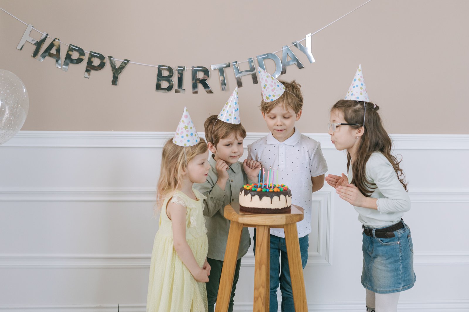 Tiered luxury birthday cake illuminated by ambient garden party lights